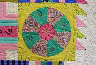 "Butterflies are Self-Propelled Flowers" close-up; pieced bu Susan Lavender; track machine quilted by Cynthia Fuelling; 1st Place Medium Pieced by Two or More. 2nd Viewers' Choice.