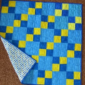 Blue and yellow square patterned quilt