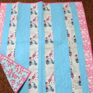 white pink and blue quilt