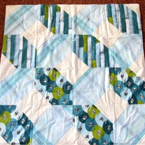multiple shades of blue and green patchwork quilt