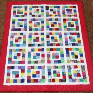 red bordered rainbow patchwork quilt