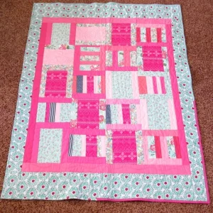pink quilt with flower border