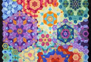 2nd Place - Large Pieced by 1; "The New Hexagon Millefiore" by Ruth Mickelson, quilted on a track machine.