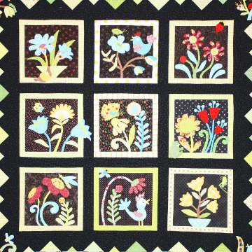 black quilt with multi color flowers