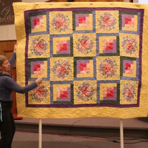 Floral Find by Donna Swanson. The floral fabric was found in a Garden Valley store and used matching fabrics from her stash. Quilt will be donated to a Young Life leader in Central Asia.