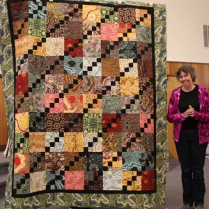 Chris Klover had a lot of Australian fabrics and got to buy more to make this for a friend who lived in Australia while earning a Masters degree. It is a celebration quilt!