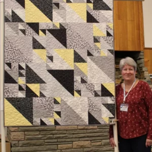 Darci made this quilt for her step-grand-daughter, Eleyna. It seems she kept trying to take her little baby brothers quilt - she liked the minkee on the back. Eleyna likes gray these days and Darci added a little variety.