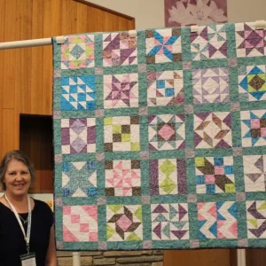 Jan Lundine made Block Party Sampler at a BBQ Schoolhouse Class. It is a Carmen Geddes pattern.