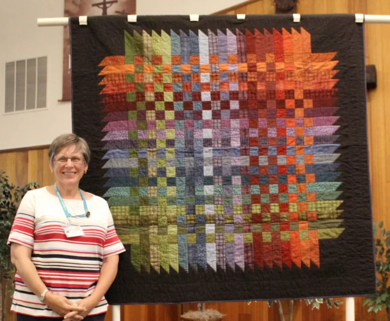 Laura Lee made and quilted "Over Down Under" for her niece. She said "this pattern is lots of fun and takes a little planning." Her niece, Sadie, just graduated from Texas Christian Univ. and was commissioned a 2nd Lieutenant in the US Marines.