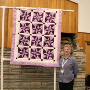 Pat Kluckhohn made Night and Day Star from a BBQ Quilters Runway pattern on this website. It is paper pieced and will be donated by her church group to refugees living in Boise.