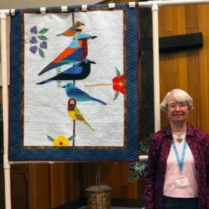 Rainforest Birds by Louise Maley was made from a pattern by Charlie Harper. He is an artist who paints birds as well as creates quilt patterns.