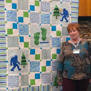 Jody Zanecki made Sasquash for her son-in-law. Big foot is his mascot! She created it using clip art and then quilted it.