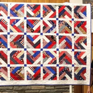 Sharon Koelling made and quilted this braided Quilt of Valor. She loves making braids after piecing 180 inches of braid, she cut it into 10