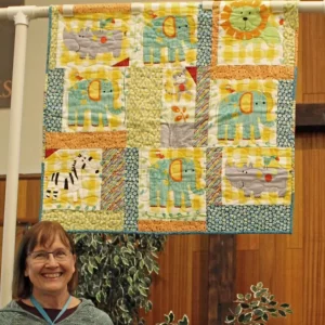 Barbara Derby made and quilted Zoo babies from a flannel panel from Quilt Expressions. A friend helped her cut it up and shared some fun fabrics.